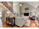 Living room featuring a staircase, fireplace, built-in shelving, and hardwood floors at 304 Gilmer Ct, Canton, GA 30115