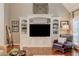 Living room showcasing built-in shelving unit, hardwood floors, and cozy armchair at 304 Gilmer Ct, Canton, GA 30115