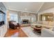 Bright living room with hardwood floors, fireplace, and large windows at 304 Gilmer Ct, Canton, GA 30115
