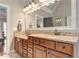 Bright main bathroom with dual sinks, granite counters, large mirror, and ample storage at 304 Gilmer Ct, Canton, GA 30115