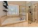 Luxurious main bathroom with jetted tub and separate glass shower with decorative tile at 304 Gilmer Ct, Canton, GA 30115