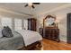 Luxurious main bedroom featuring ornate wood furniture, hardwood floors, and natural light at 304 Gilmer Ct, Canton, GA 30115