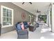 A covered outdoor patio has a lounge area with furniture and decorations at 304 Gilmer Ct, Canton, GA 30115