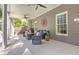 A covered patio with ceiling fans has plenty of seating and a view of the backyard at 304 Gilmer Ct, Canton, GA 30115