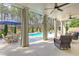 Covered outdoor patio overlooking pool with ceiling fans and outdoor furniture at 304 Gilmer Ct, Canton, GA 30115