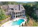 Aerial view of home featuring a large kidney-shaped pool, with lounge seating and an outdoor patio at 304 Gilmer Ct, Canton, GA 30115