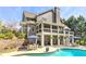 A beautiful pool with plenty of lounge chairs and umbrellas for enjoying the outdoors at 304 Gilmer Ct, Canton, GA 30115