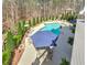 Aerial view of a beautiful pool surrounded by lush landscaping and mature trees at 304 Gilmer Ct, Canton, GA 30115