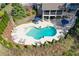Aerial shot showcasing the backyard pool with lounge chairs, mature landscaping, and an outdoor patio at 304 Gilmer Ct, Canton, GA 30115