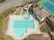 Aerial view of the community pool area featuring a slide, pool and mature landscaping at 304 Gilmer Ct, Canton, GA 30115