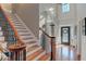 Elegant staircase with hardwood steps, decorative iron railings, and a view into the light-filled foyer at 304 Gilmer Ct, Canton, GA 30115