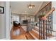 View of staircase and living room with hardwood floors, fireplace, and iron railing at 304 Gilmer Ct, Canton, GA 30115