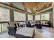 Relaxing sunroom with wood-plank ceiling, tile floor, lots of windows, and comfortable wicker furniture at 304 Gilmer Ct, Canton, GA 30115