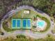 Aerial view featuring tennis courts, a pool, a playground, and mature landscaping at 304 Gilmer Ct, Canton, GA 30115