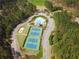Aerial view highlighting community tennis courts, pool, playground, and lush landscaping at 304 Gilmer Ct, Canton, GA 30115