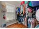 Bright walk-in closet featuring custom shelving, hats as decorations, providing ample storage and organization at 304 Gilmer Ct, Canton, GA 30115
