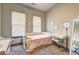 Sunlit bedroom featuring a cozy twin bed, two windows, and a cute vanity with modern decor at 898 Oak Sw St # 1101, Atlanta, GA 30310