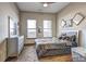 Sunlit bedroom featuring a cozy queen-sized bed, a ceiling fan, and ample natural light from two windows at 898 Oak Sw St # 1101, Atlanta, GA 30310
