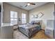 This cozy bedroom features a comfy queen-sized bed, a ceiling fan, and ample natural light from two windows at 898 Oak Sw St # 1101, Atlanta, GA 30310