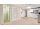 Basement kitchenette features white cabinets, a sink, carpet floors and multiple doors at 1235 Saint Ives Ct, Suwanee, GA 30024