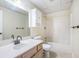 Modest bathroom features a single sink vanity, white toilet, and a tub with shower at 1235 Saint Ives Ct, Suwanee, GA 30024