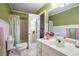 Bright bathroom featuring a single sink vanity, toilet, decorative shower curtain, and white wainscoting at 1235 Saint Ives Ct, Suwanee, GA 30024