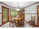Cozy breakfast nook with wood table and chairs, offering views of the outdoors through large windows at 1235 Saint Ives Ct, Suwanee, GA 30024