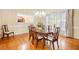 Dining Room featuring wood floors, chandelier, and natural light at 1235 Saint Ives Ct, Suwanee, GA 30024