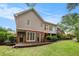 Back exterior view of a house featuring a brick foundation, patio, and upper level deck at 1235 Saint Ives Ct, Suwanee, GA 30024