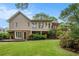 Exterior view of the house with a well-manicured lawn and a multi-level deck at 1235 Saint Ives Ct, Suwanee, GA 30024