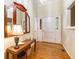 Bright foyer featuring hardwood floors, a decorative mirror, and a white front door with sidelights at 1235 Saint Ives Ct, Suwanee, GA 30024