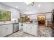 Spacious kitchen with island, stainless steel dishwasher, and view into living areas at 1235 Saint Ives Ct, Suwanee, GA 30024