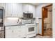 Kitchen featuring white cabinetry, stainless steel appliances and tiled backsplash at 1235 Saint Ives Ct, Suwanee, GA 30024
