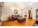 Spacious living room with hardwood floors, vaulted ceilings, and a classic grandfather clock at 1235 Saint Ives Ct, Suwanee, GA 30024