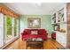 Cozy living room with large windows, stone fireplace, and built-in shelving at 1235 Saint Ives Ct, Suwanee, GA 30024
