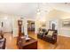 Open-concept living room with hardwood floors and views of the dining room and kitchen at 1235 Saint Ives Ct, Suwanee, GA 30024