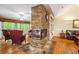 Bright living room features a stone fireplace, hardwood floors, and natural light at 1235 Saint Ives Ct, Suwanee, GA 30024