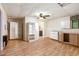 Spacious living area with hardwood floors, built-in storage, ceiling fan, and a connecting bathroom at 1235 Saint Ives Ct, Suwanee, GA 30024