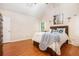 Relaxing bedroom with beautiful hardwood floors, large windows, and a comfortable bed topped with a blue throw at 1235 Saint Ives Ct, Suwanee, GA 30024