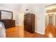 Bedroom showing a dresser, hardwood floors, and doorway leading to the rest of the house at 1235 Saint Ives Ct, Suwanee, GA 30024