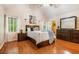Spacious primary bedroom boasts vaulted ceilings, a large window, wood floors and a comfortable bed at 1235 Saint Ives Ct, Suwanee, GA 30024