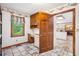 Mud Room featuring storage, counter space, a window view, and tile floors at 1235 Saint Ives Ct, Suwanee, GA 30024