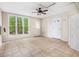 Bright sunroom features large windows, two doors, and a ceiling fan for comfort and style at 1235 Saint Ives Ct, Suwanee, GA 30024