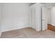 An empty bedroom with a closet, carpet floors, and white walls at 2814 Cobb Place Manor Ct, Marietta, GA 30066