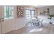 Bright breakfast nook area with modern table, chairs, large windows, and door to outside at 3814 Whaley Ct, Snellville, GA 30039