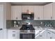 Modern kitchen with white cabinets, stainless steel appliances, and granite countertops at 3814 Whaley Ct, Snellville, GA 30039