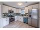 Well-lit kitchen with stainless steel appliances, white cabinets, and light hardwood floors at 3814 Whaley Ct, Snellville, GA 30039