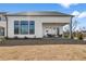 The back of home shows a covered patio and nice backyard at 486 Broom Dr, Cumming, GA 30040
