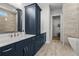Bathroom features double vanity with storage, tile flooring, and a walk-in closet at 486 Broom Dr, Cumming, GA 30040