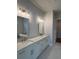 Double sink bathroom with white cabinets, quartz countertops, and modern fixtures at 486 Broom Dr, Cumming, GA 30040